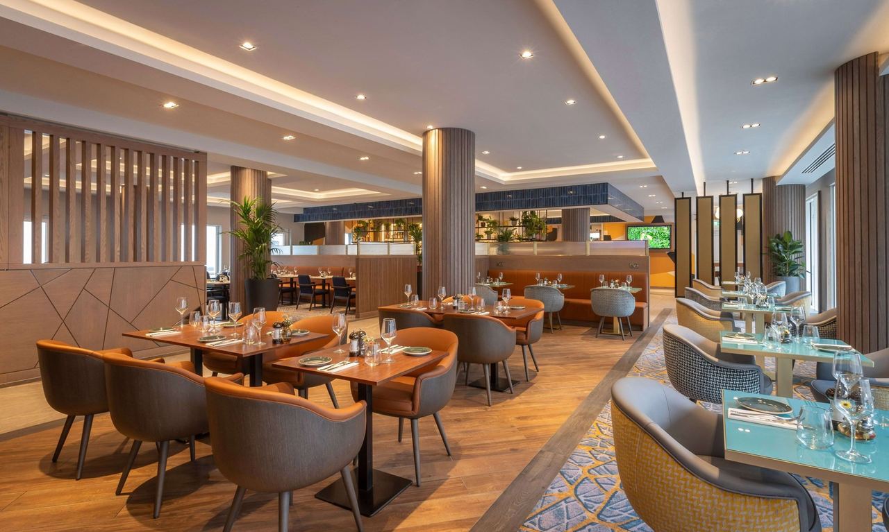 The restaurant at the Maldron Hotel Brighton, with timber screens, curved banquettes and window tables