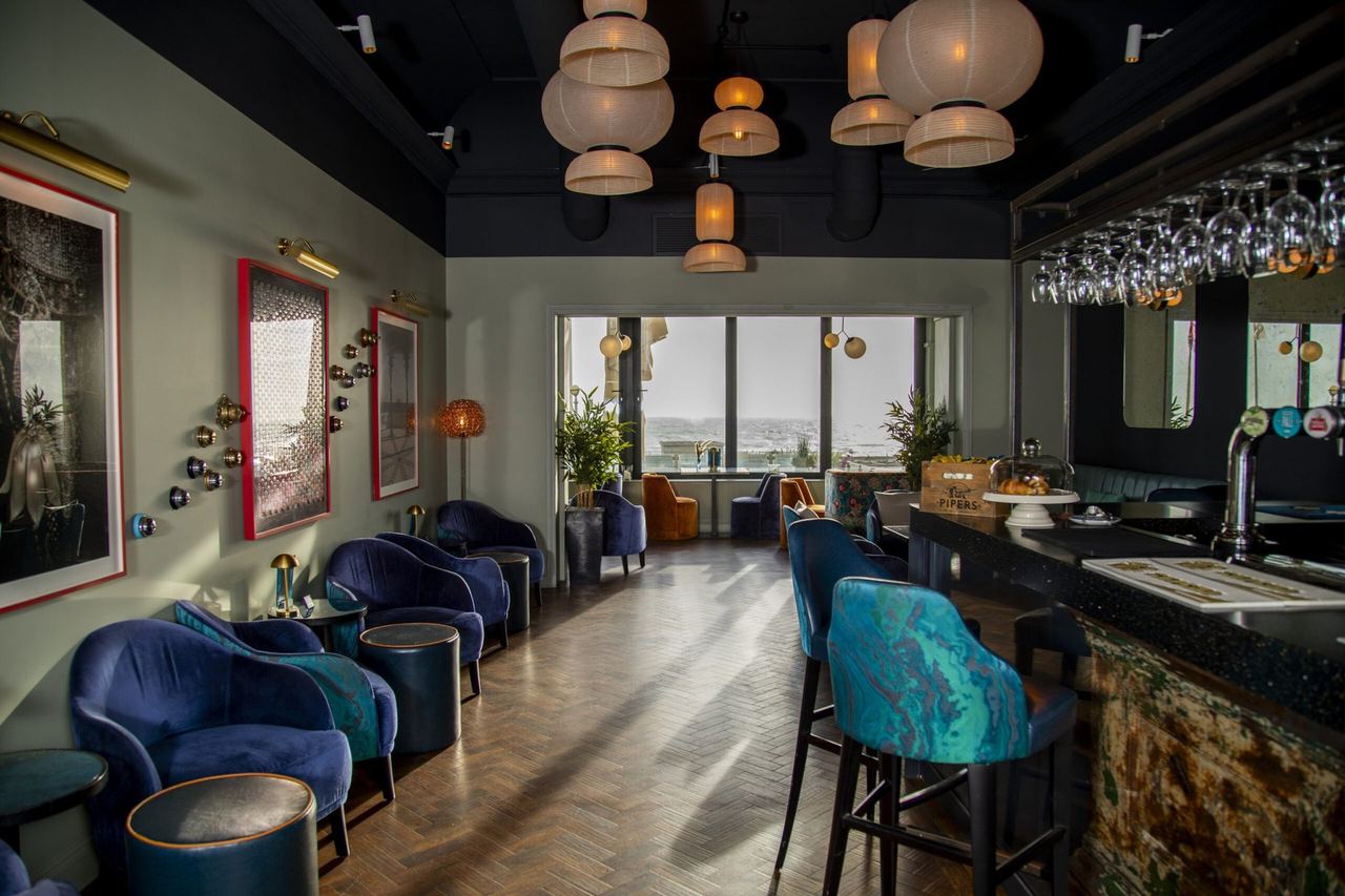 The bar at the Mercure Brighton Seafront, with blue velvet seats and paper lanterns