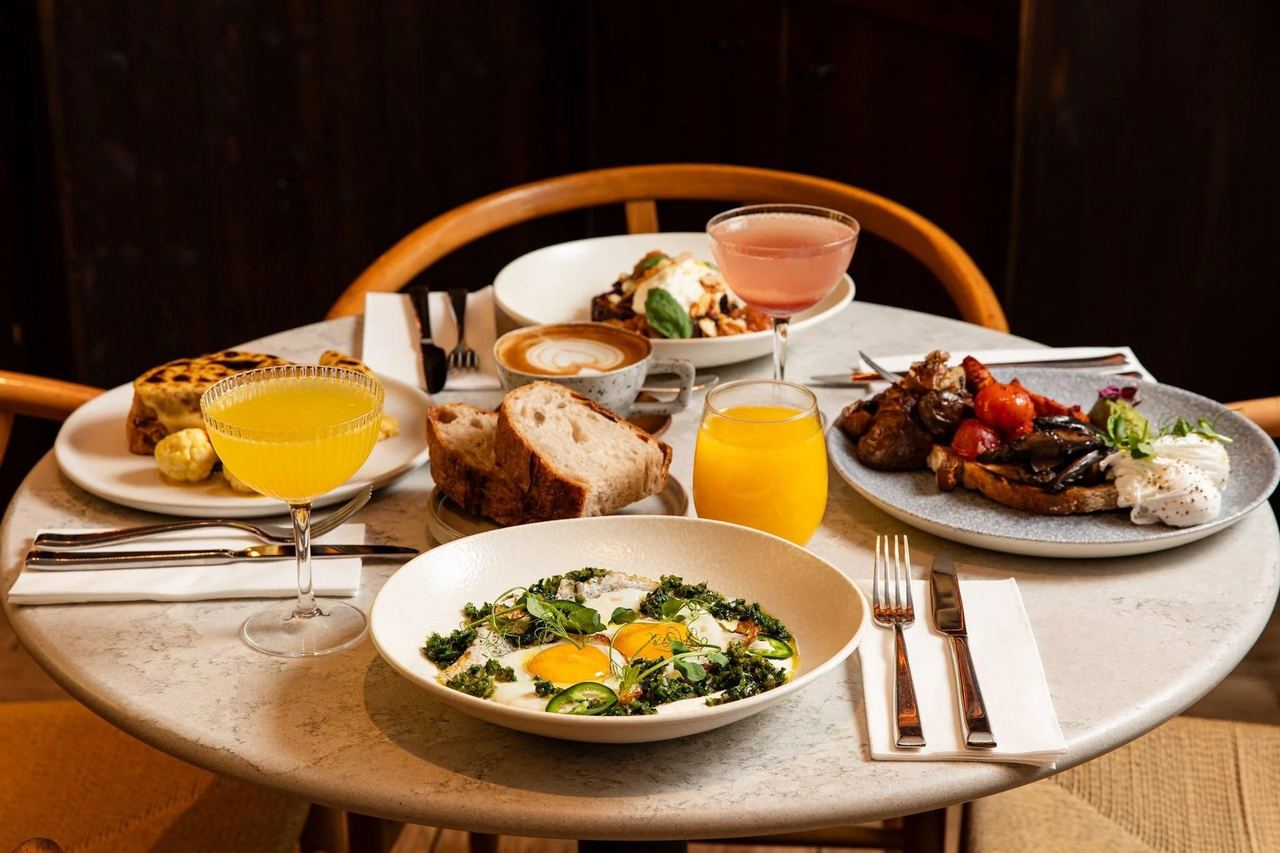 Breakfast plates, juice and coffee on a marble table at Lost in the Lanes