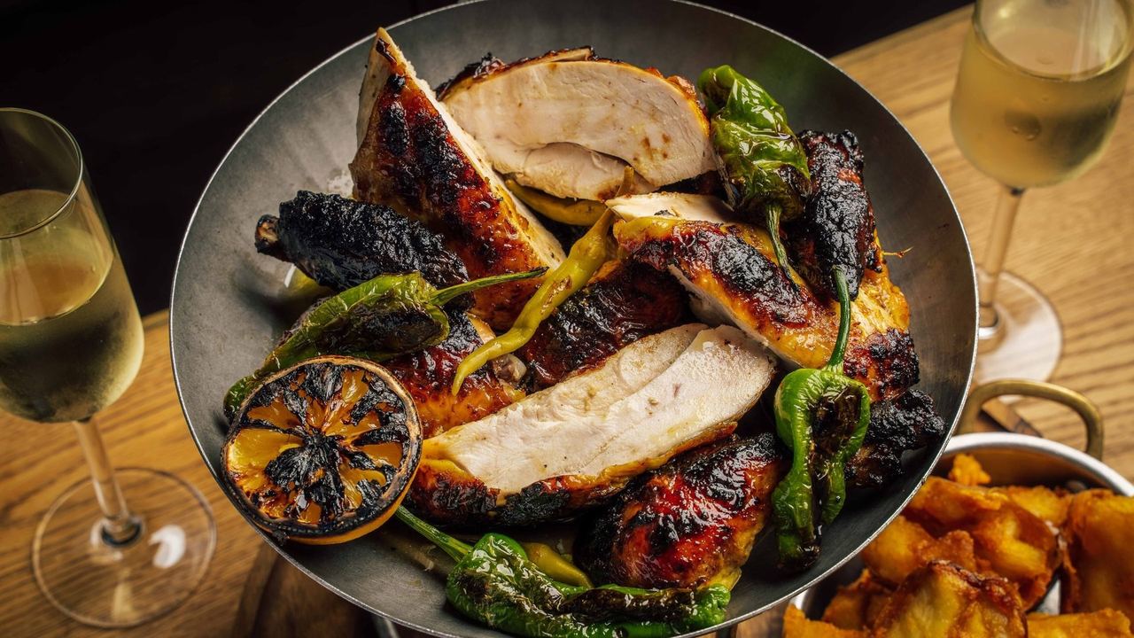 Charred rotisserie chicken with peppers at The Crazy Goose