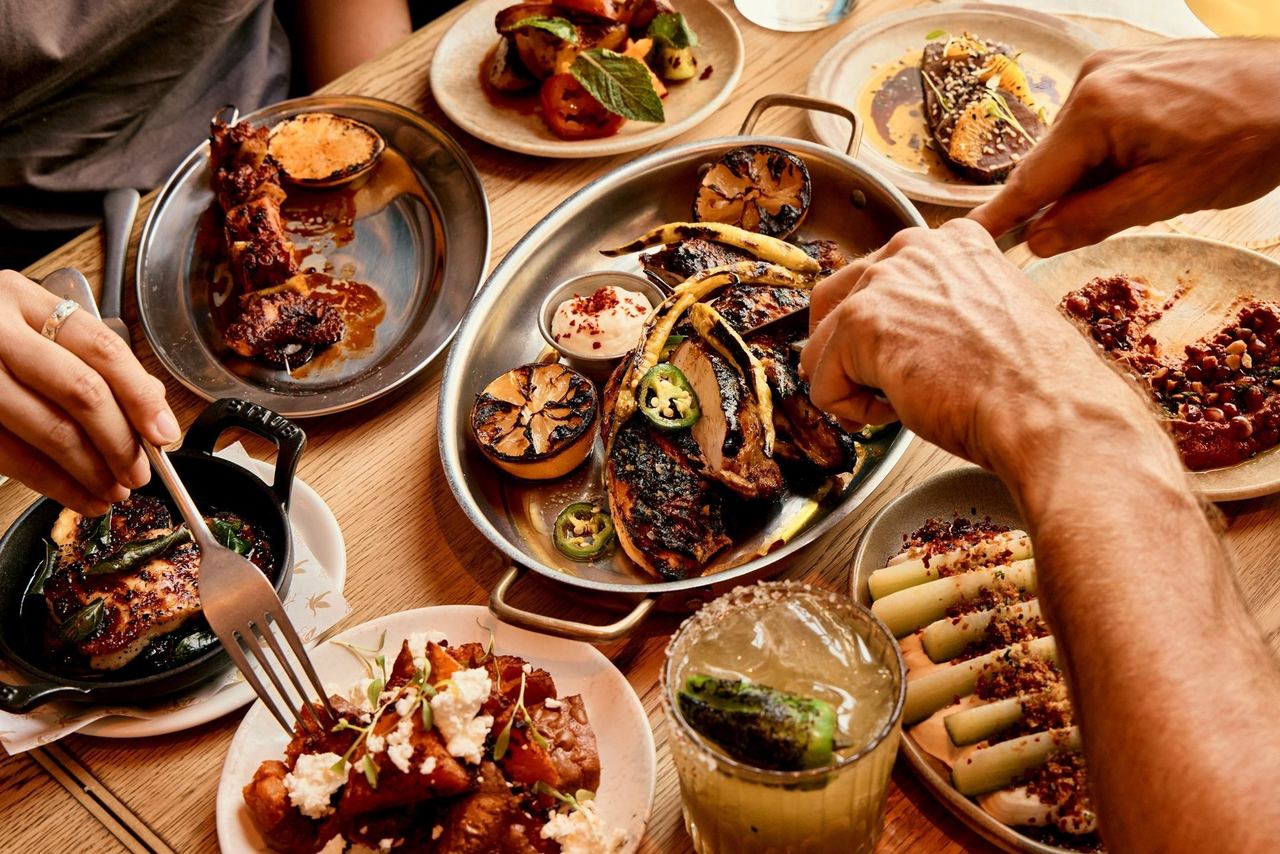Fire-cooked sharing plates on a wooden table at The Crazy Goose