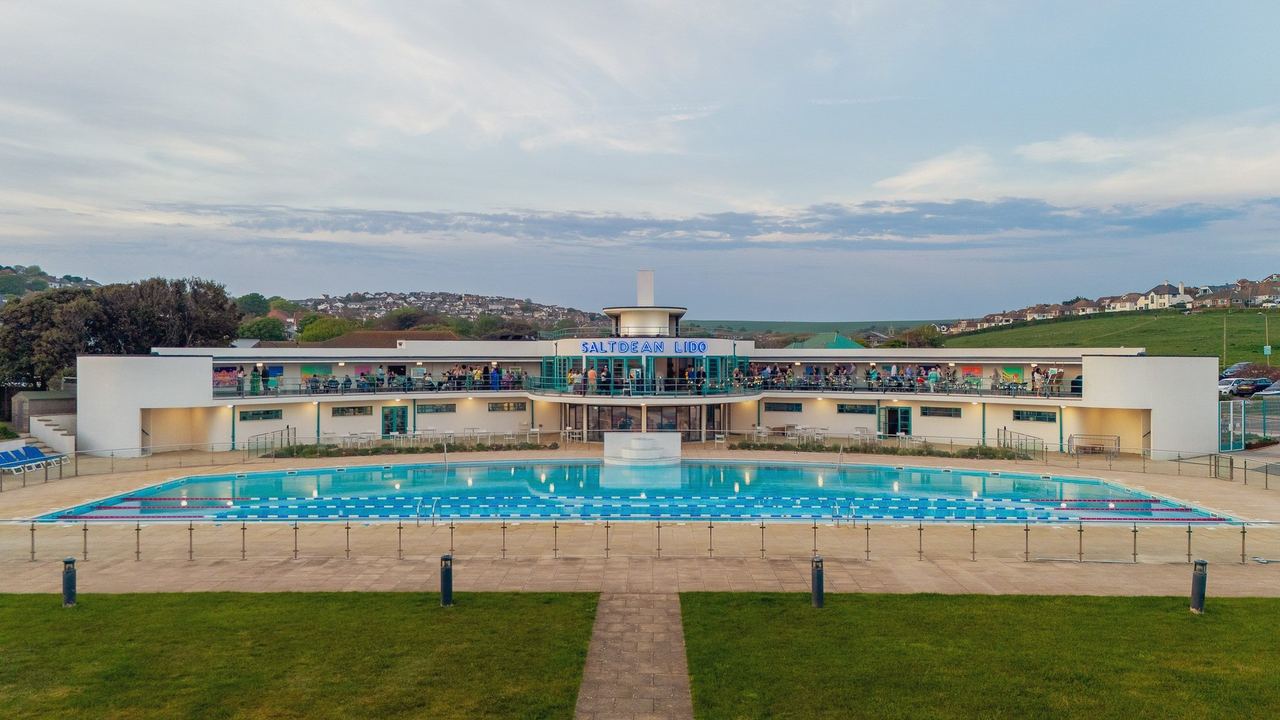 Saltdean Lido’s curving Art Deco building and pool under the Downs