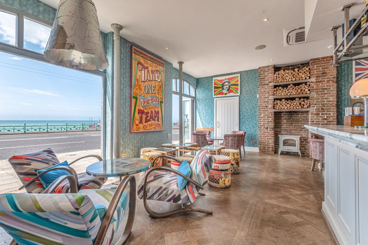 HarBar + Kitchen at Harbour Hotel, with striped chairs and windows on to the seafront