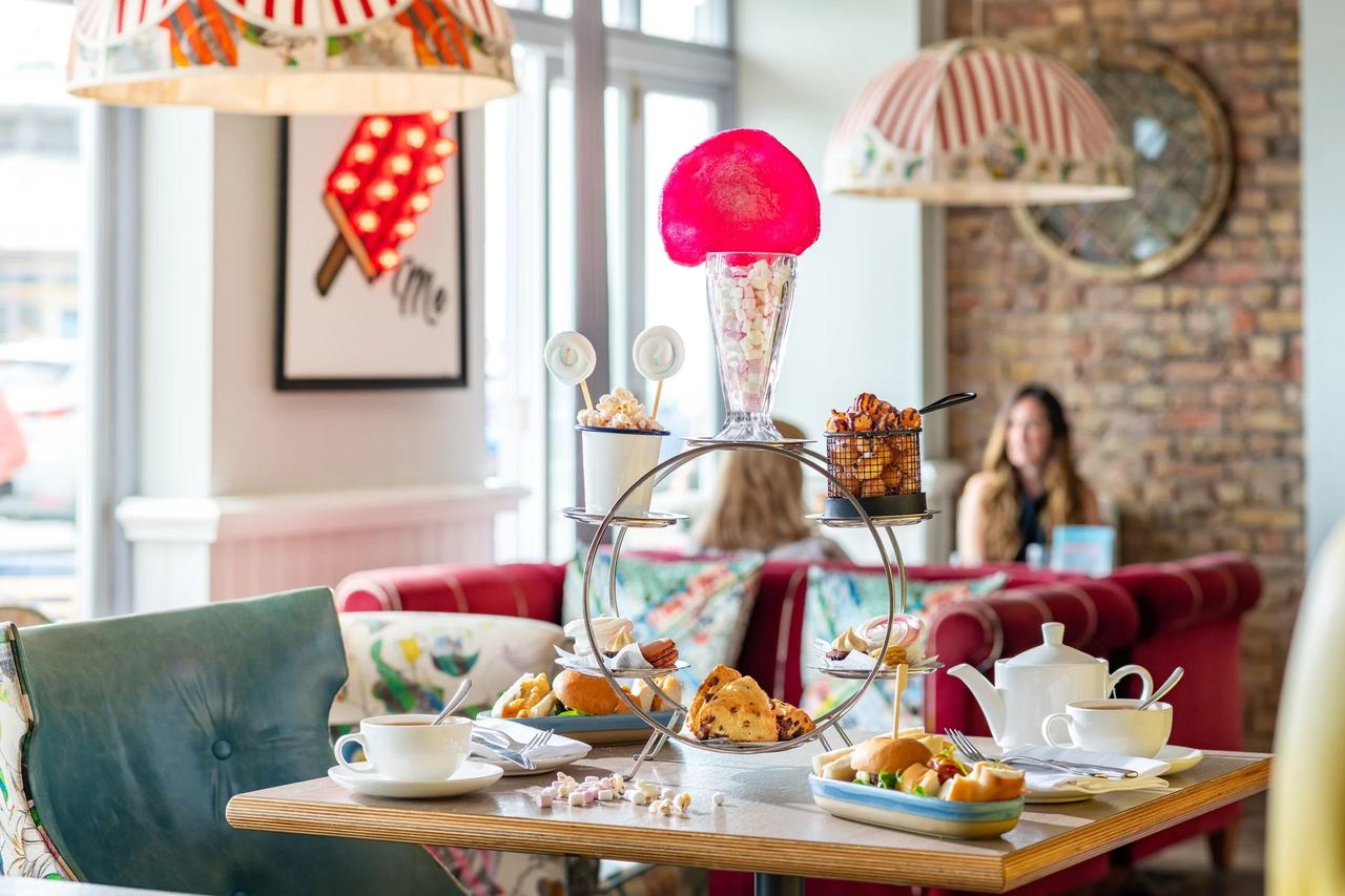 The fairground afternoon tea stand with a pink sundae and cakes in HarBar + Kitchen