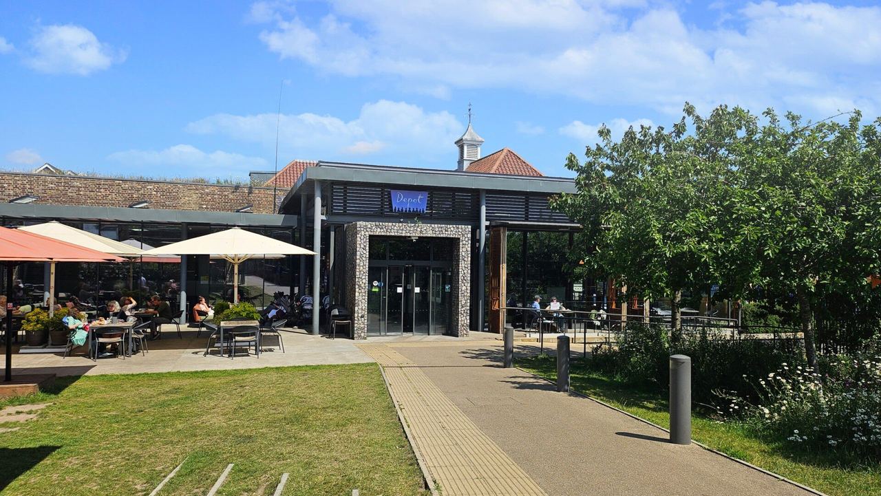 The front of Depot in Lewes, with its café terrace and lawn in sunshine