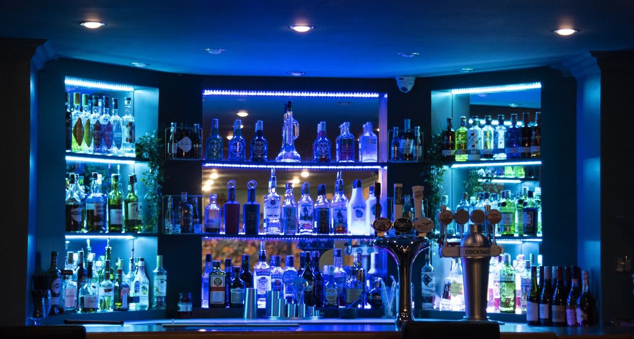 The blue-lit bar at East Beach Hotel