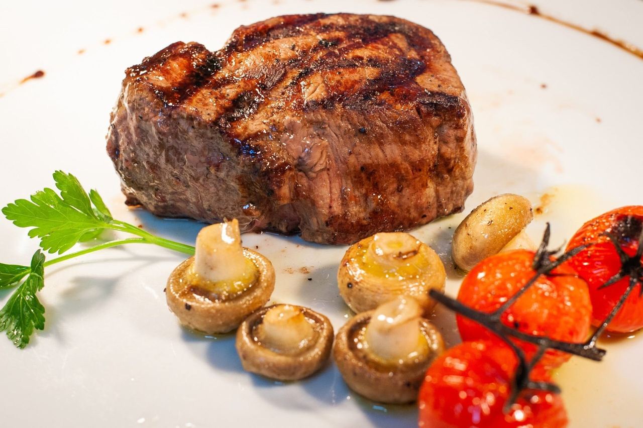 A grilled fillet steak with mushrooms and roasted tomatoes at Pomodoro e Mozzarella