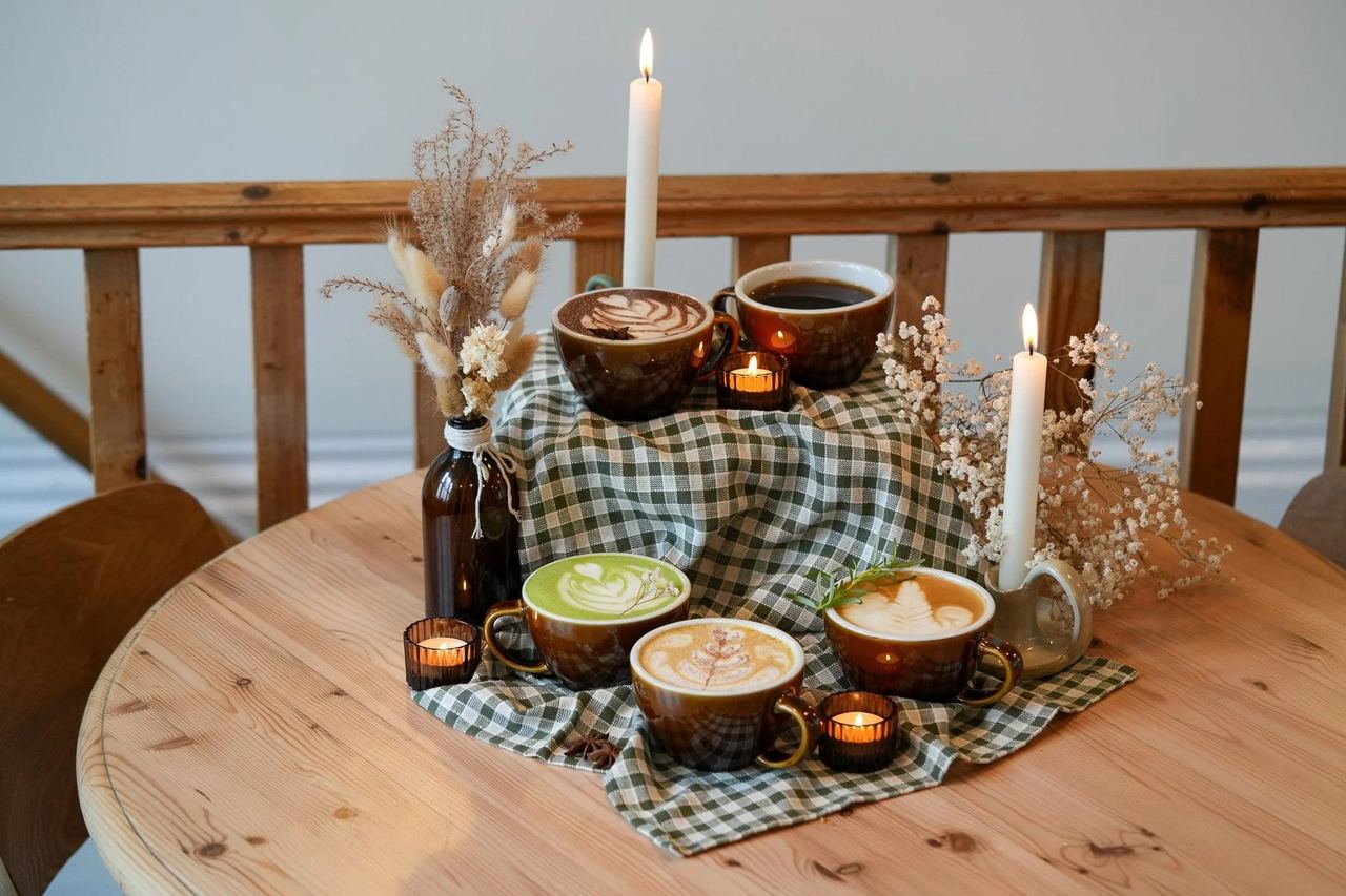 Latte art and candles on a round table at Skylark