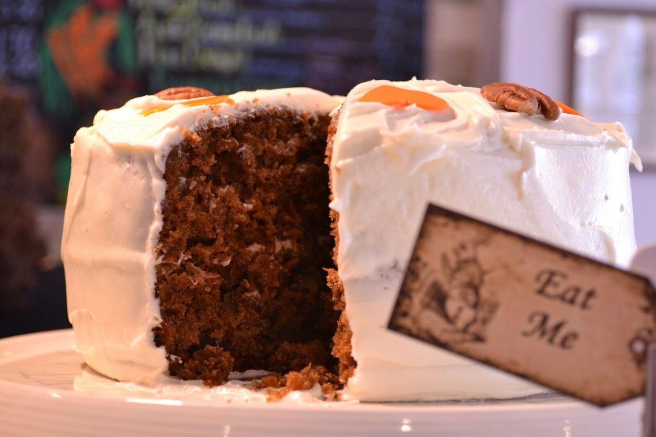 A carrot cake with an “Eat Me” tag at Coffee and Carrot